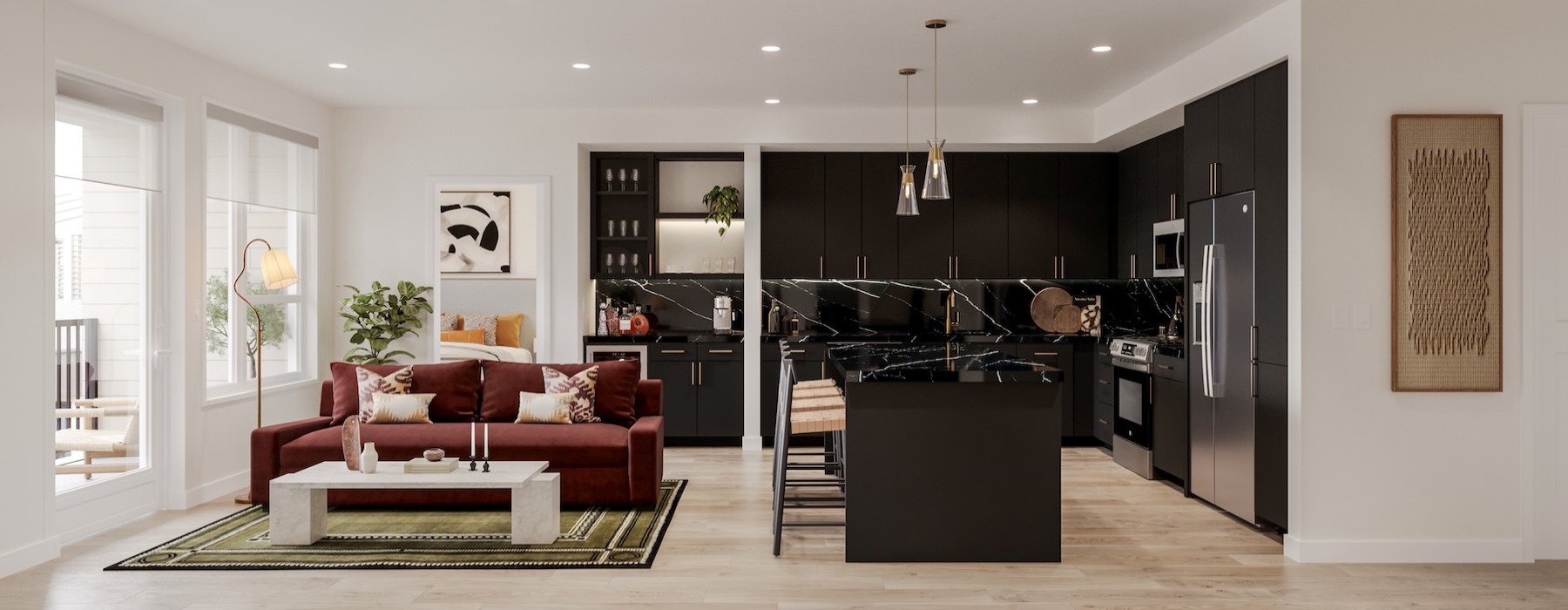 a black kitchen and a living room with a couch and a table