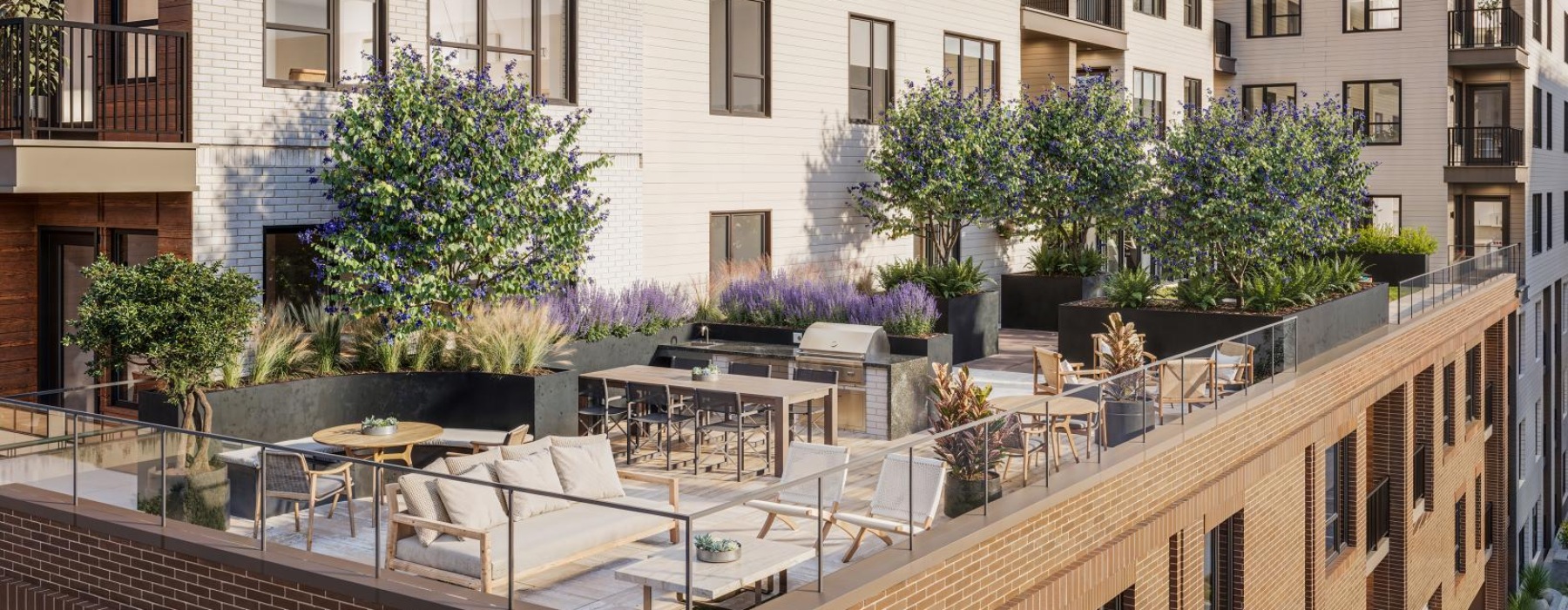 a rooftop patio with couches, tables and chairs
