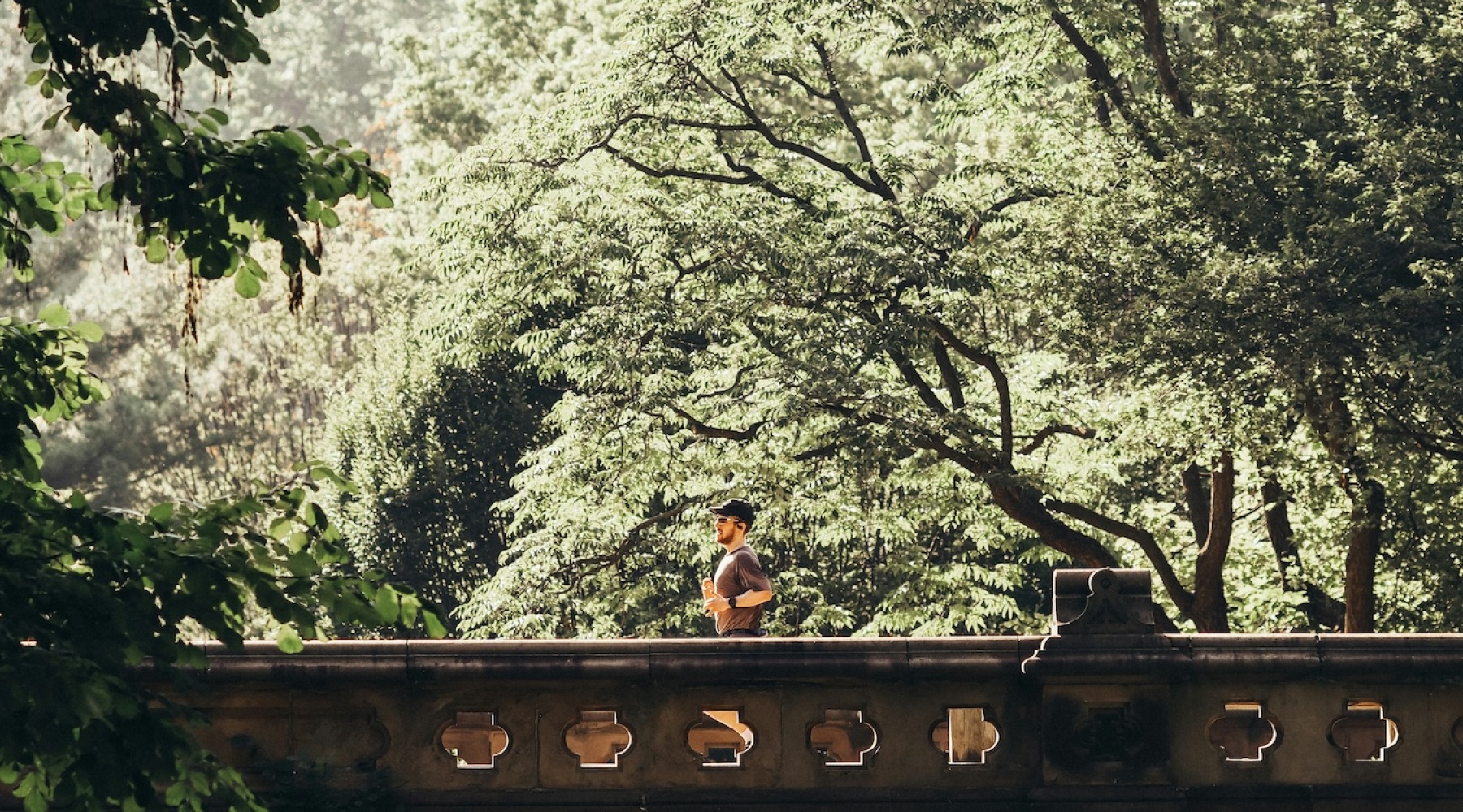a person running in a bridge in a park
